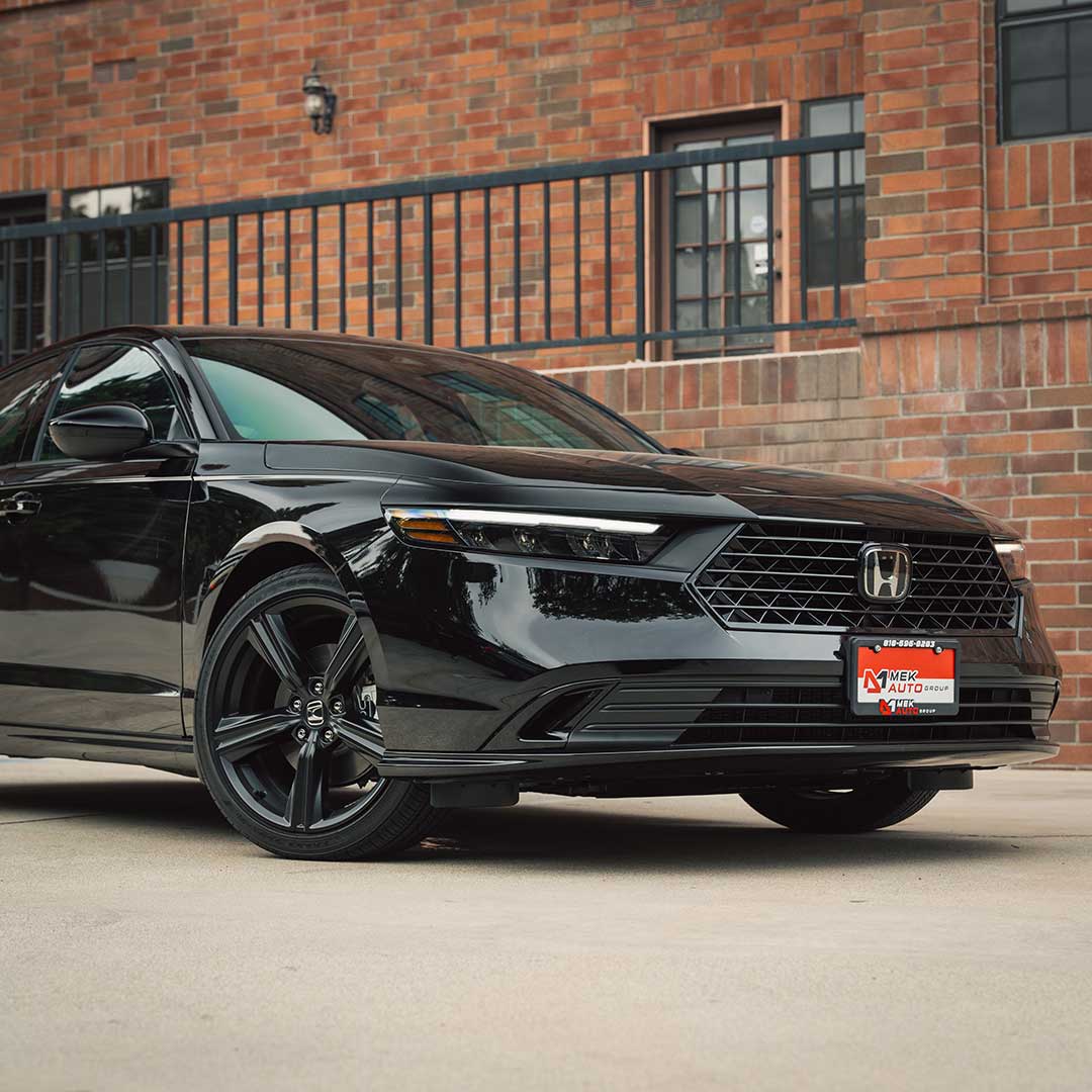 black honda accord hybrid detailed front shot in front of red brick bulding